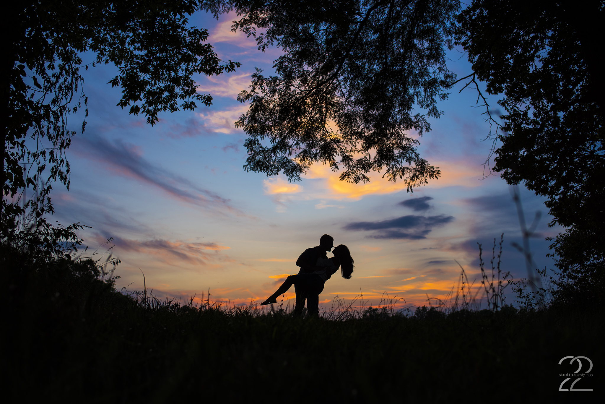 Man dips woman in a field at sunset in Dayton, Ohio by Dayton Wedding Photographer Studio 22 Photography
